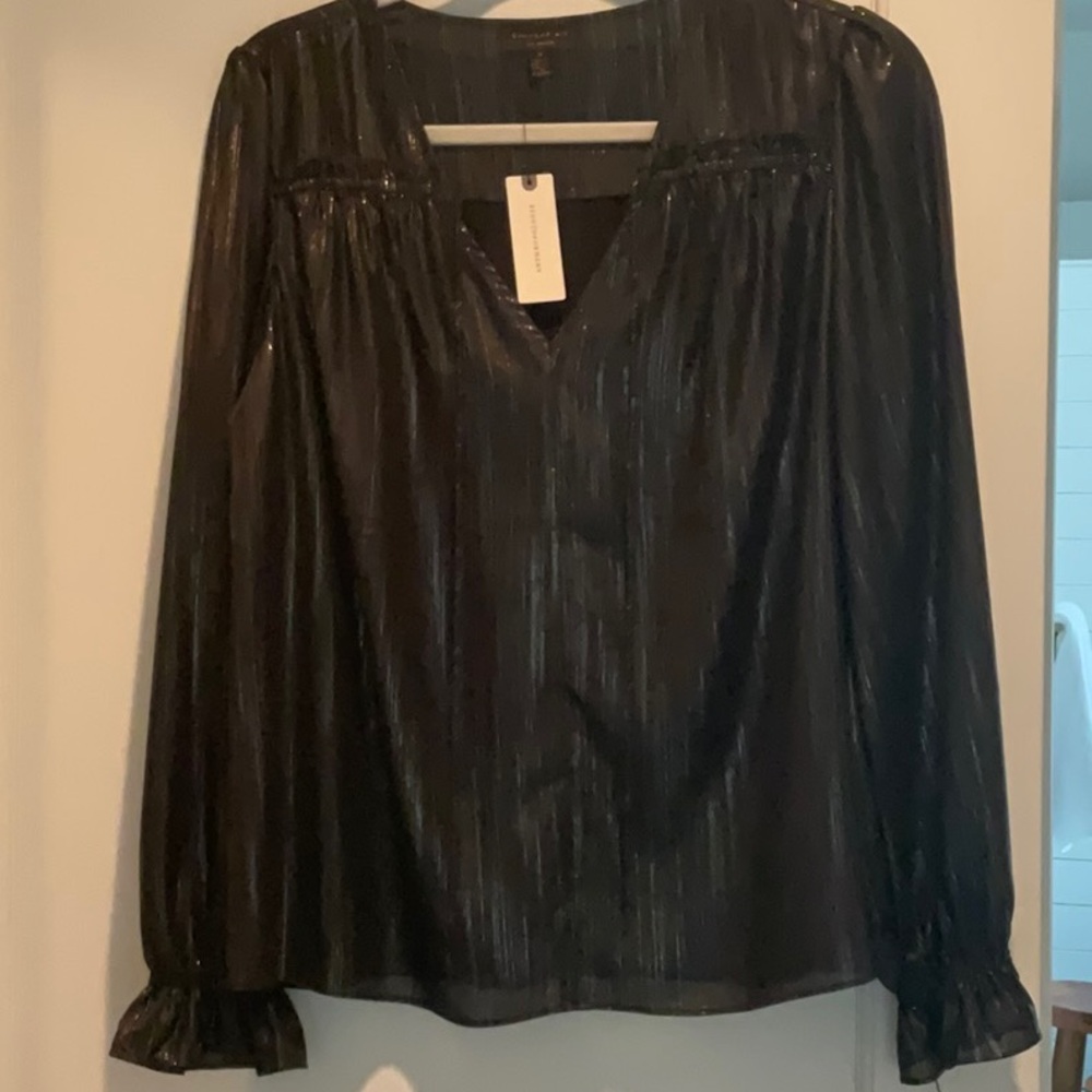 Black and silver blouse with puff shoulders and elastic ruffle cuffs